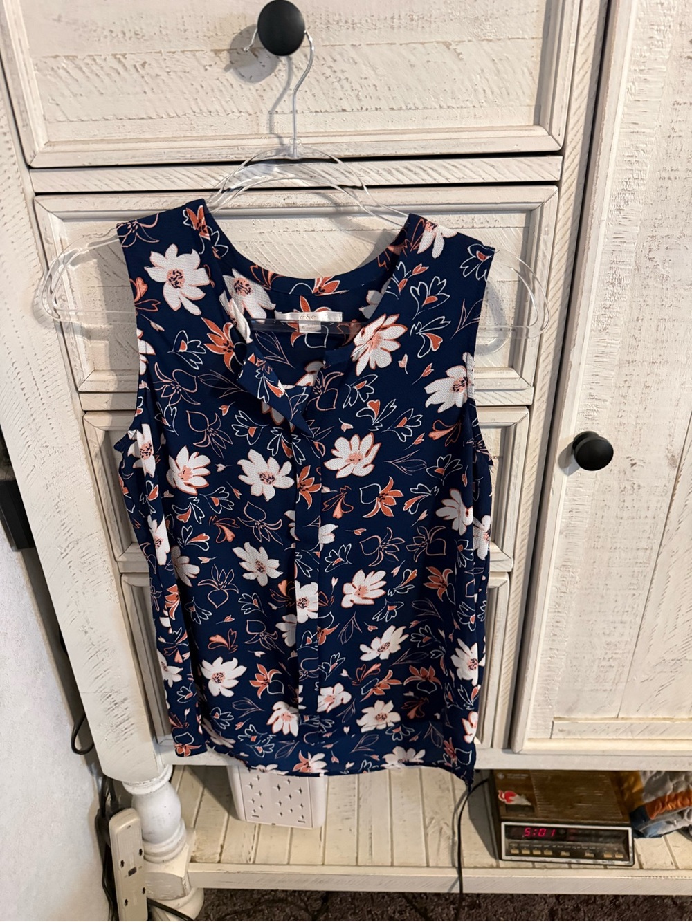 Sleeveless Navy Floral Blouse with Button-Front Detail